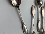 five spoons and two spoon spoons on a table