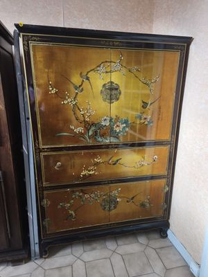 a cabinet that has been painted with flowers and birds