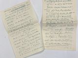 two pieces of paper with writing on them sitting on a table