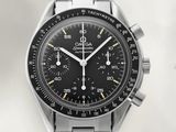 a close up of a watch with a black face and a silver bracelet