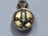 a close up of a badge with a knife and a cross on it