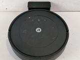 a close up of a black round object on a white surface