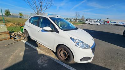 a small white car parked in a parking lot