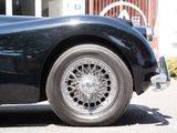 a close up of a black car parked in front of a building