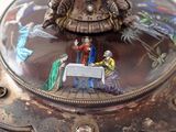 a decorative box with a picture of a man and woman at a table