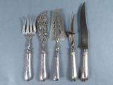 four forks and a knife on the table