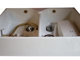 a white sink with a faucet and a faucet in it