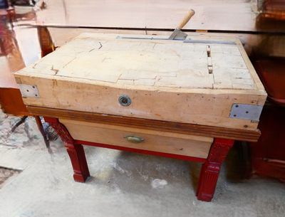 a wooden box with a hammer on it sitting on a table