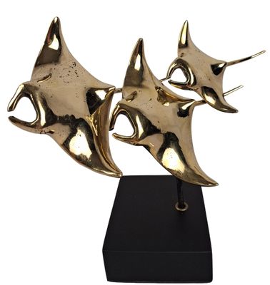 a pair of brass sculptures on a black stand on a white background