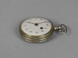 an old pocket watch with a chain on a table