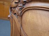 a wooden bed with a carved headboard and foot board