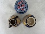 two cups and a saucer sitting on a table