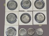 six different types of silver coins are shown in a display case