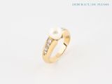 an image of a pearl and diamond ring on a white background