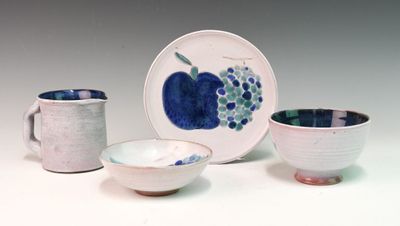 three cups and a plate on a white table