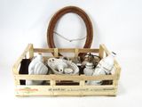 a wooden crate filled with assorted items on a white surface