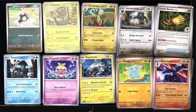pokemon cards are lined up in a row on a table