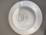 a white plate with a picture on it sitting on a table