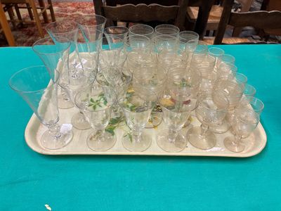 a tray full of empty wine glasses on a table