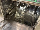 stainless steel dishwasher in a commercial kitchen with stainless steel trays