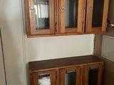 a kitchen with a refrigerator and a microwave in it