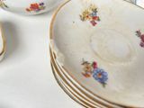 a lot of plates and bowls sitting on a table
