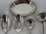 five spoons and a plate on the table