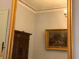 a mirror on a table in a room with a mirror on the wall