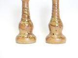 two vases that are sitting on a white surface