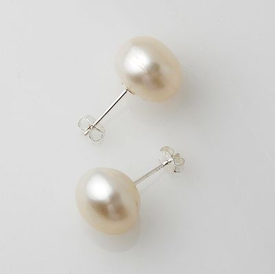 pair of pearl earrings on a white surface