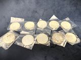 six bags of cookies sitting on top of a table covered in plastic