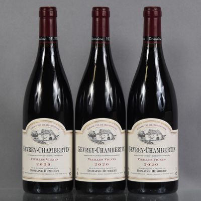 three bottles of wine are lined up on a table