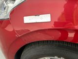 a close up of a red car with a sticker on it