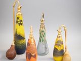 several different colored vases are lined up on a white surface