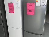 two refrigerators that have pink stickers on them