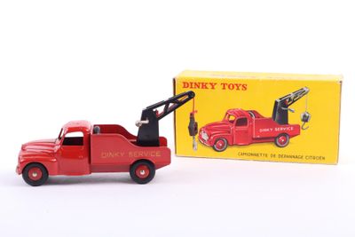 a red toy truck with a crane on the back of it