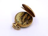 an image of a gold pocket watch on a white surface