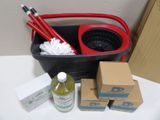 a bucket of cleaning supplies on a table next to a box of cleaning supplies