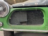 a close up of the front of a green car