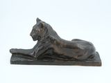 bronze statue of a lion on a base on a white background