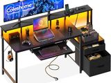 a computer desk with two monitors and a keyboard on it