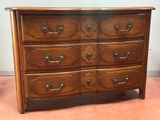 a wooden dresser with many drawers on it in a room
