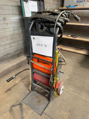 an image of a small hand truck with a hose attached to it