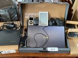 a laptop, mp3 player, and other electronics on a table
