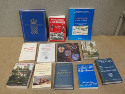 several books are sitting on a table in front of a wall
