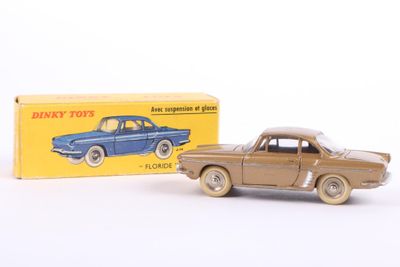 an old toy car and box of toys on a white surface