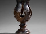 a brown vase with a hole in the middle of it