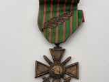 an image of a medal with a cross and a ribbon