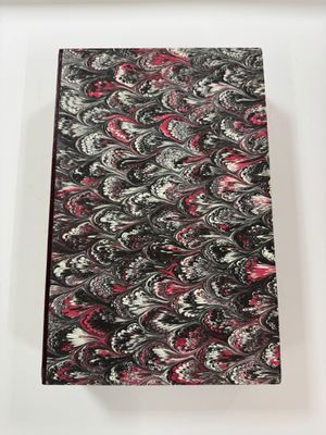 a close up of a notebook with a red and black cover