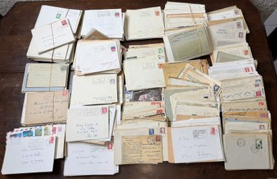 pile of old letters and envelopes sitting on a wooden table